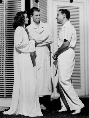 Hepburn and Stewart on set with director George Cukor.